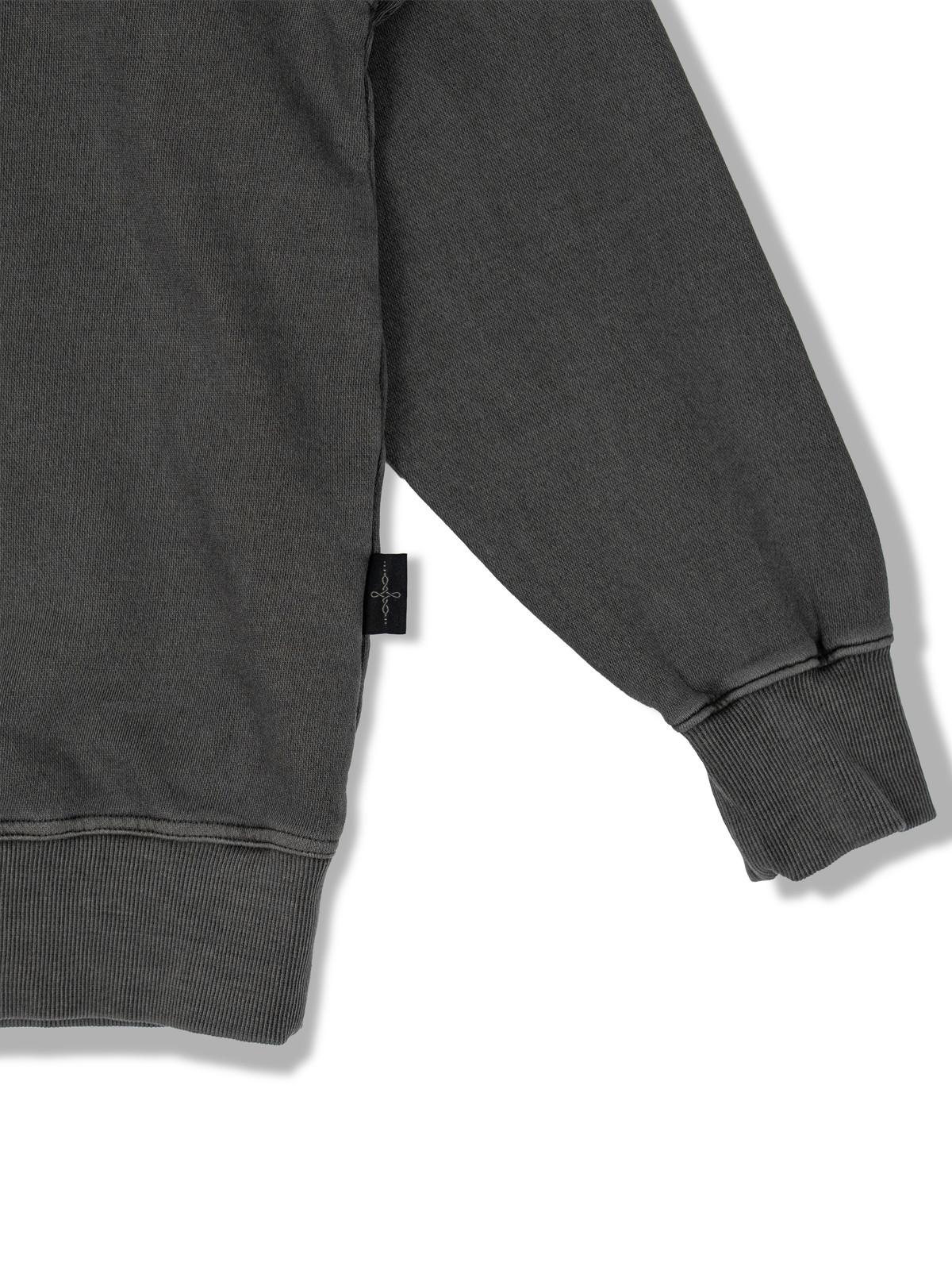 Real studio photograph of UNDERKNOT sweatshirt sleeve cuffs and ribbed hem